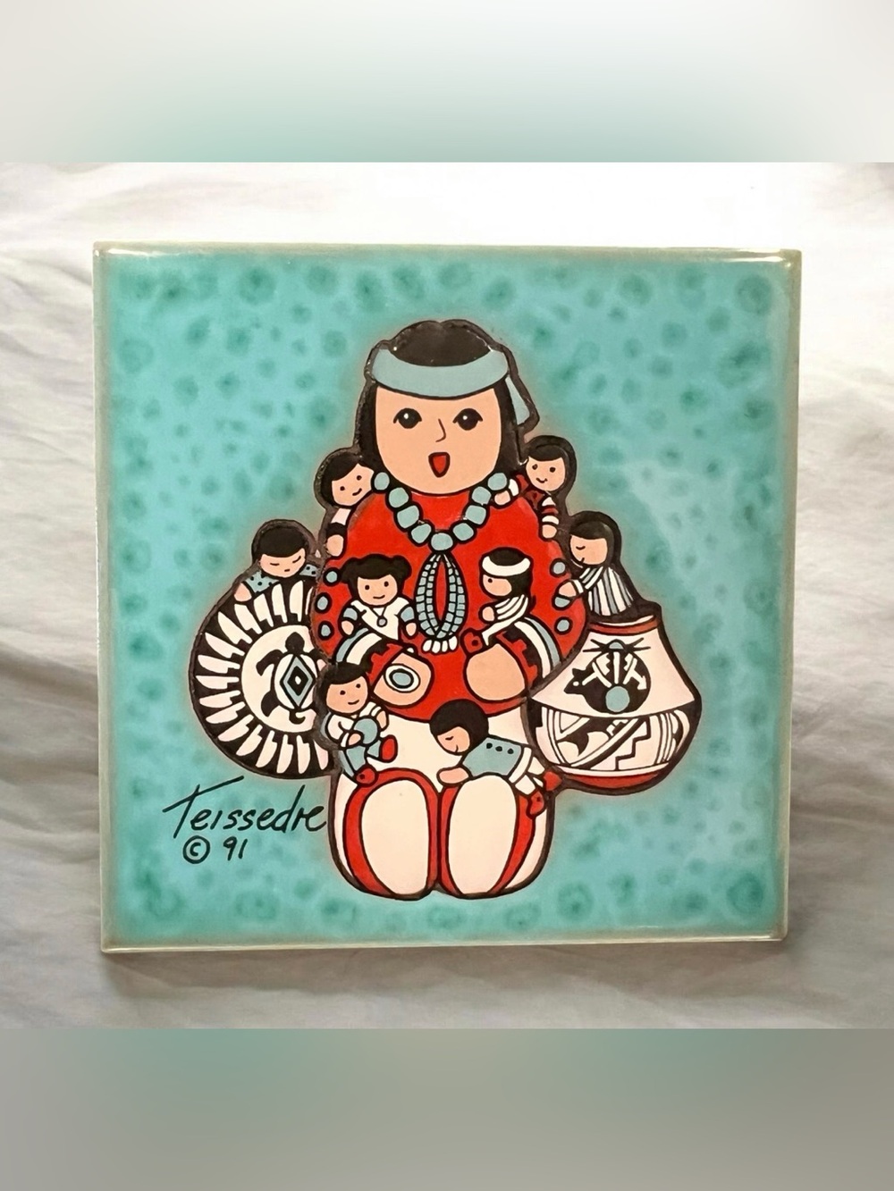Signed Teissedre ceramic tile featuring a Native American Storyteller figure.